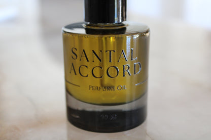 Bottle of Santal Accord perfume oil on a light background